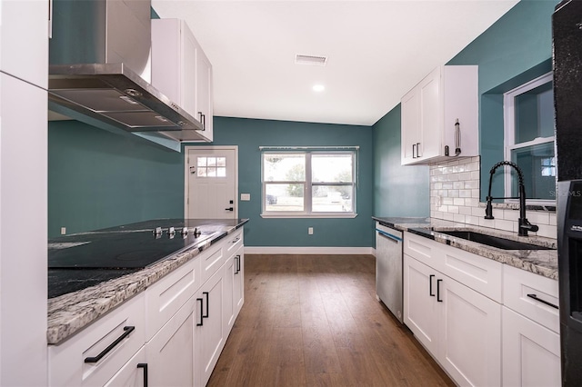 kitchen with visible vents, wall chimney exhaust hood, black electric stovetop, stainless steel dishwasher, and a sink