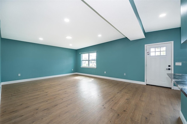 interior space featuring recessed lighting, dark wood-style flooring, and baseboards