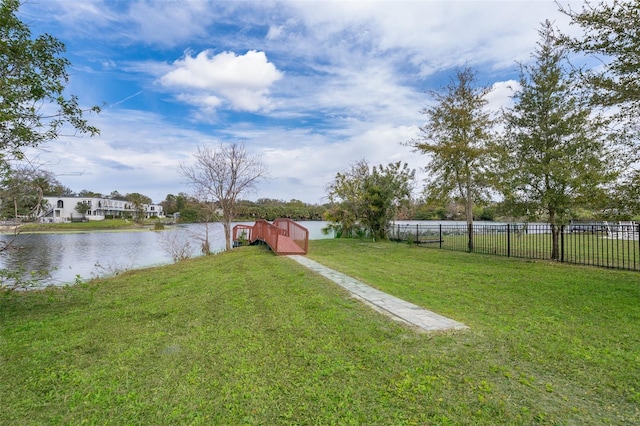 view of yard with a water view and fence