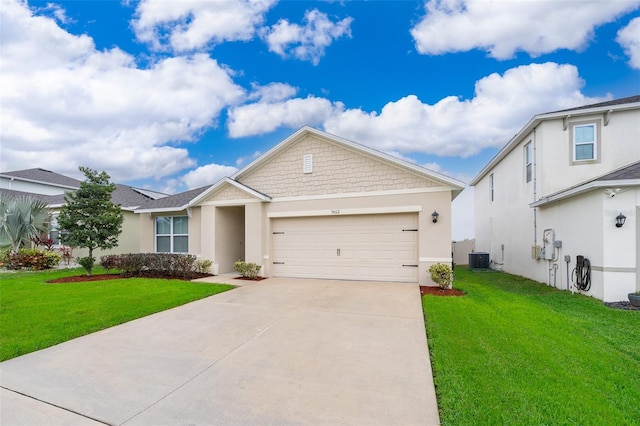 ranch-style home with a garage, a front lawn, and stucco siding