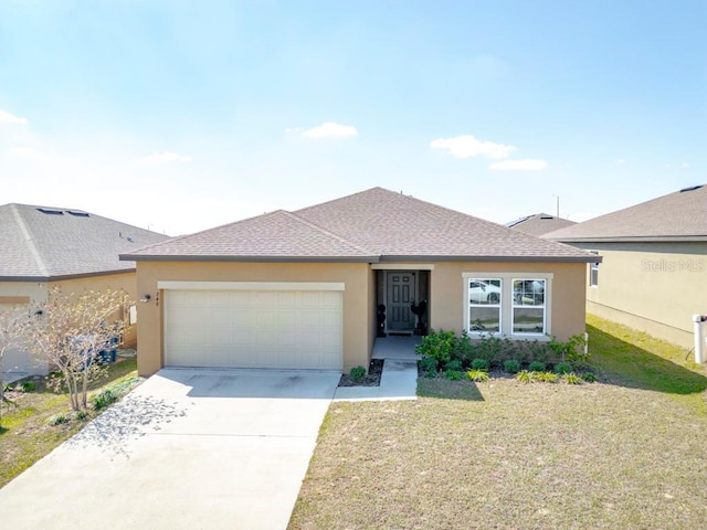 view of front of property with an attached garage, driveway, a front lawn, and stucco siding