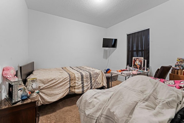 bedroom with carpet floors and a textured ceiling