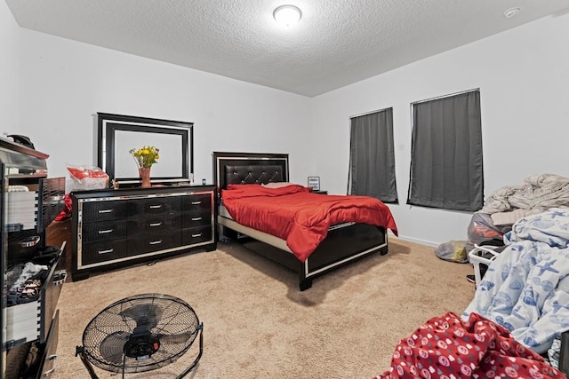 bedroom featuring a textured ceiling and light colored carpet