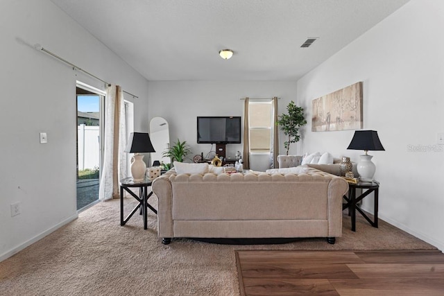 living area with visible vents and baseboards