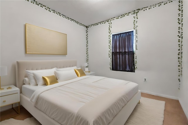 bedroom with baseboards and carpet flooring