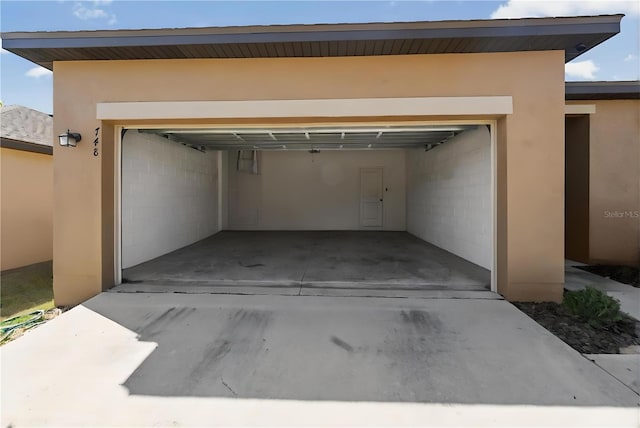 garage with concrete driveway