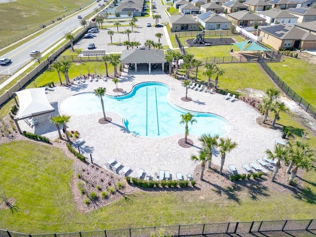 community pool with a patio area, a residential view, fence, and a gazebo