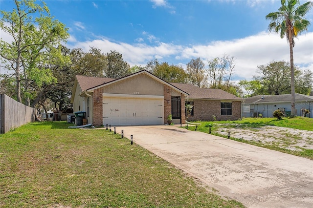 single story home with a garage, driveway, fence, a front yard, and brick siding