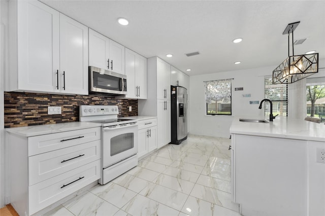 kitchen featuring marble finish floor, visible vents, backsplash, appliances with stainless steel finishes, and a sink