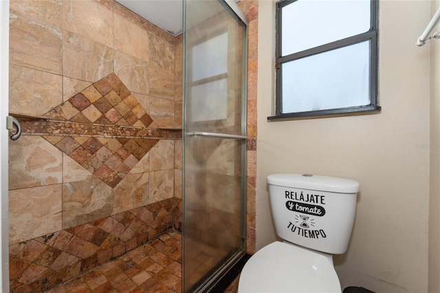 full bathroom with a shower stall and toilet