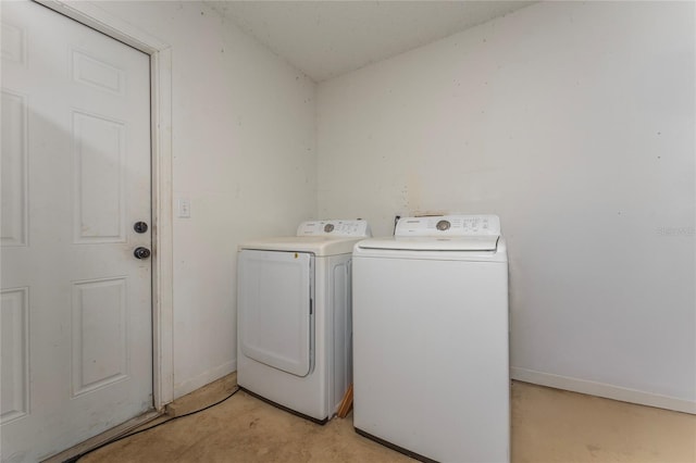 laundry area featuring laundry area, baseboards, and separate washer and dryer