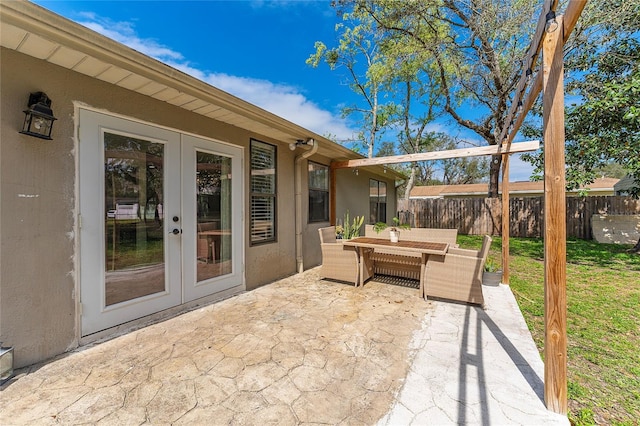 view of patio / terrace featuring french doors, outdoor dining area, and fence