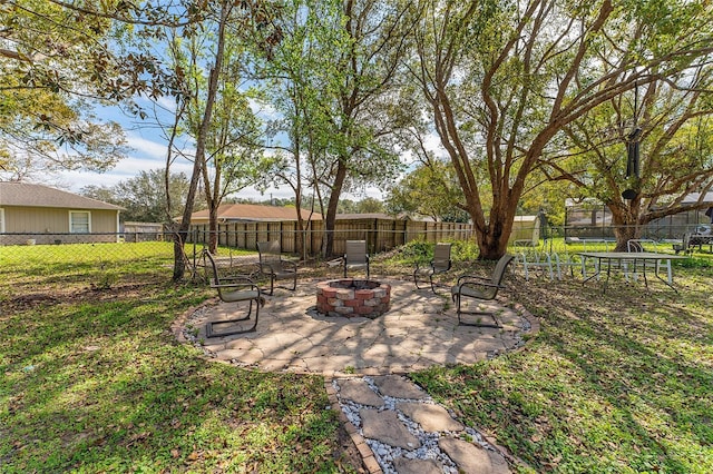 view of yard featuring a patio area, an outdoor fire pit, and a fenced backyard