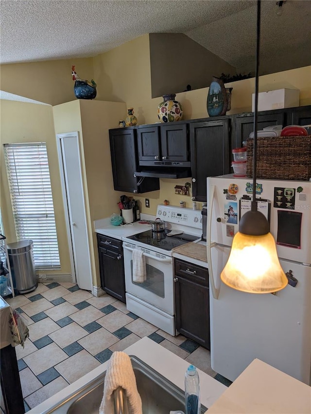 kitchen with light floors, lofted ceiling, light countertops, white appliances, and under cabinet range hood