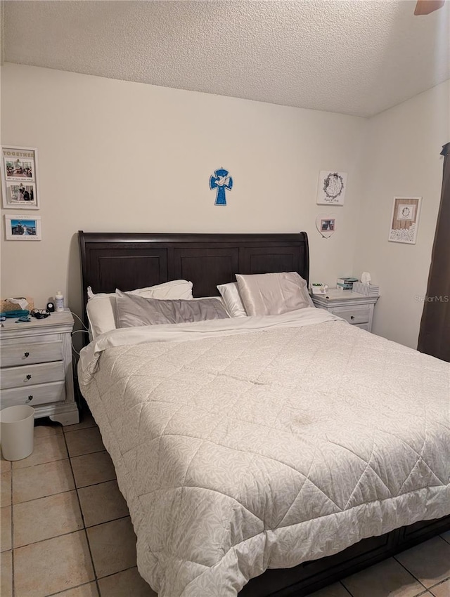 bedroom featuring tile patterned flooring and a textured ceiling