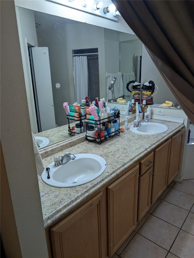 bathroom featuring double vanity, tile patterned flooring, and a sink