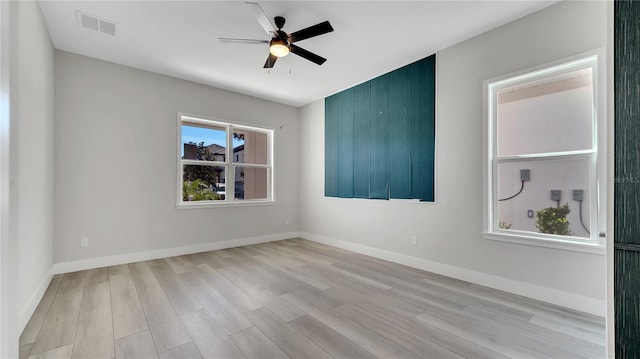 unfurnished room featuring visible vents, baseboards, light wood-style floors, and ceiling fan