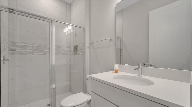 full bath with toilet, a stall shower, and vanity