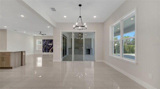 interior space with visible vents, recessed lighting, ceiling fan with notable chandelier, and baseboards