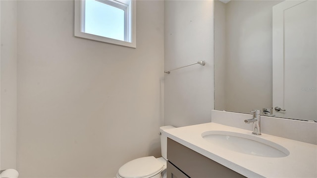 bathroom with toilet and vanity