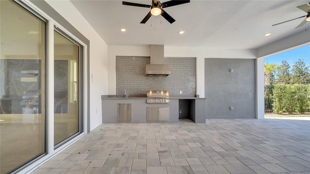 view of patio / terrace featuring a sink, exterior kitchen, ceiling fan, and grilling area