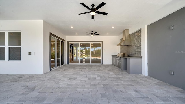 view of patio / terrace with an outdoor kitchen and ceiling fan