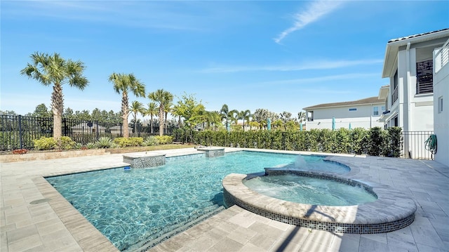 view of swimming pool with a pool with connected hot tub and fence