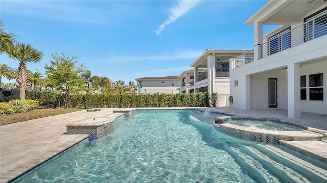 view of pool with a patio area, a pool with connected hot tub, a ceiling fan, and fence