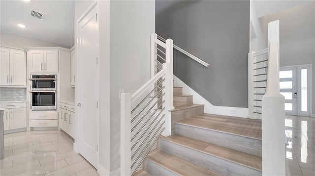 staircase with visible vents and recessed lighting