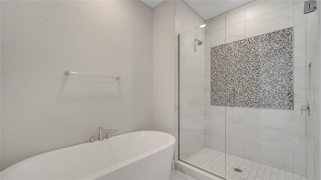 bathroom featuring a freestanding bath and a stall shower