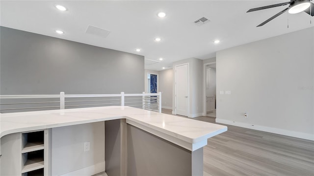 interior space with light wood-style flooring, recessed lighting, visible vents, and baseboards