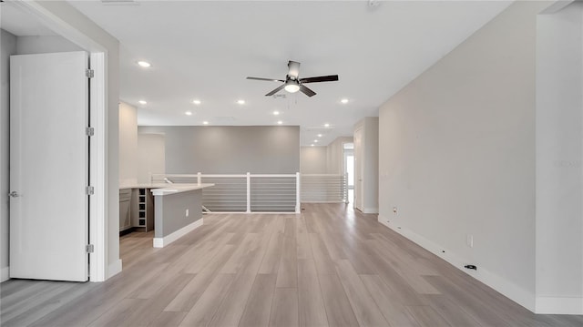 unfurnished room with recessed lighting, baseboards, light wood-type flooring, and ceiling fan