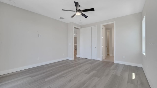 unfurnished bedroom featuring visible vents, a ceiling fan, connected bathroom, light wood-style floors, and baseboards