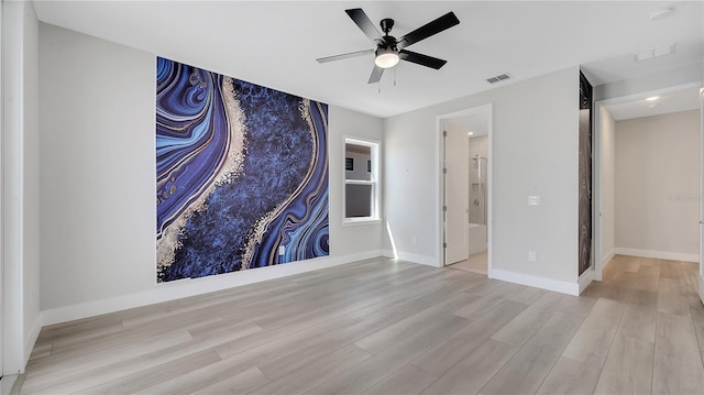 empty room with visible vents, ceiling fan, light wood-type flooring, and baseboards