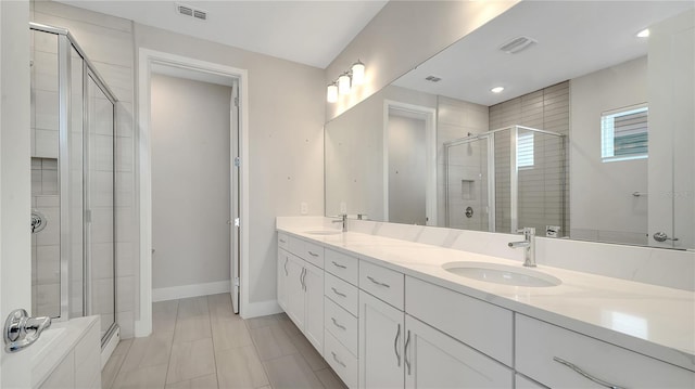 full bathroom featuring a sink, visible vents, baseboards, and a shower stall