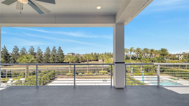 view of patio / terrace with a balcony and a ceiling fan