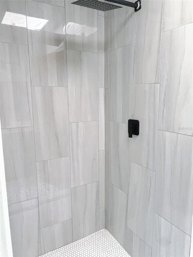 bathroom with a tile shower