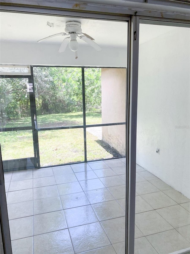 unfurnished sunroom with a ceiling fan