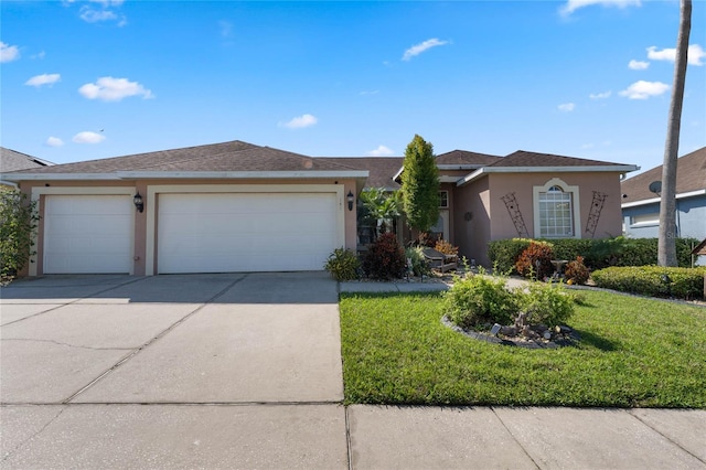 view of front of house with an attached garage, a shingled roof, concrete driveway, stucco siding, and a front lawn