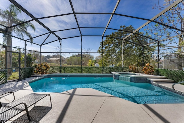 view of swimming pool featuring a lanai, a pool with connected hot tub, and a patio