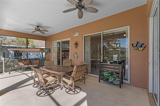 sunroom / solarium featuring a ceiling fan