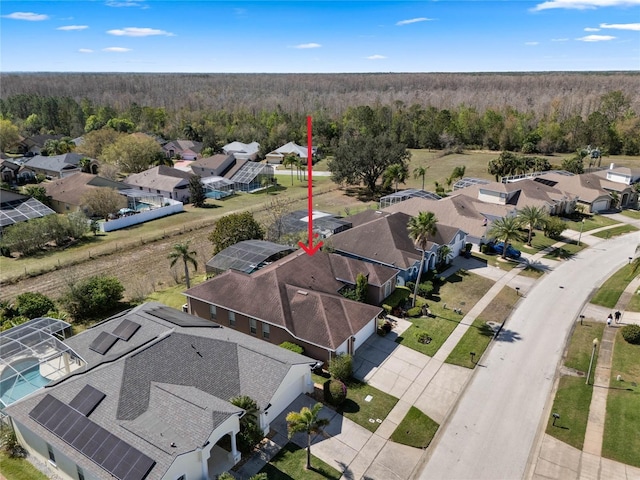 birds eye view of property featuring a forest view and a residential view