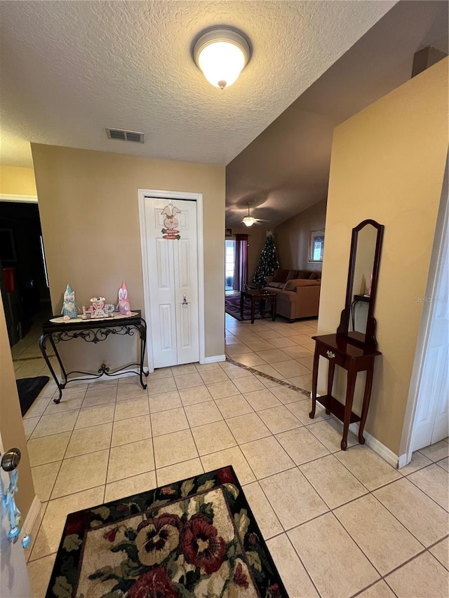 3449 Village Green Ct, Saint Cloud, FL 34772 - foyer entrance with light tile patterned floors, baseboards, visible vents, and a textured ceiling