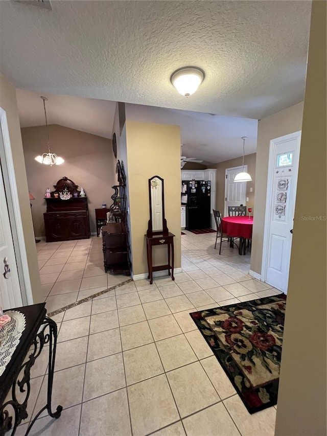 3449 Village Green Ct, Saint Cloud, FL 34772 - hallway featuring light tile patterned flooring, vaulted ceiling, and a textured ceiling