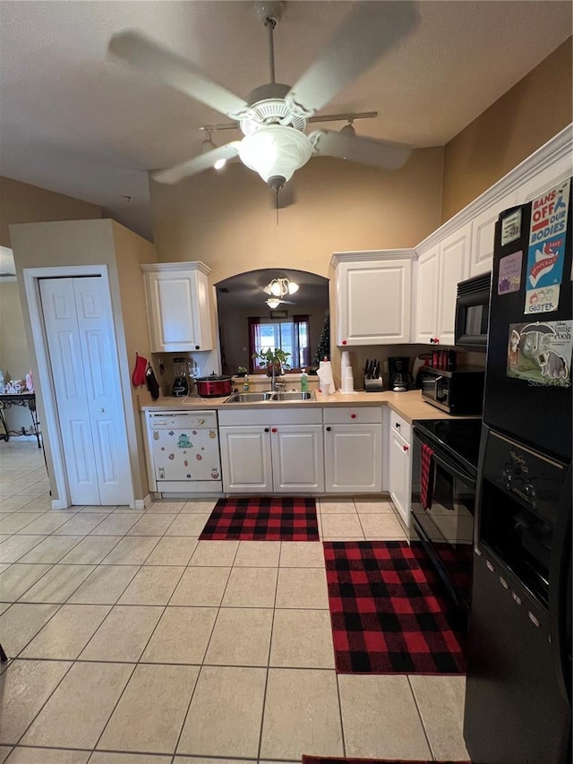 3449 Village Green Ct, Saint Cloud, FL 34772 - kitchen with arched walkways, light countertops, black appliances, a sink, and light tile patterned flooring