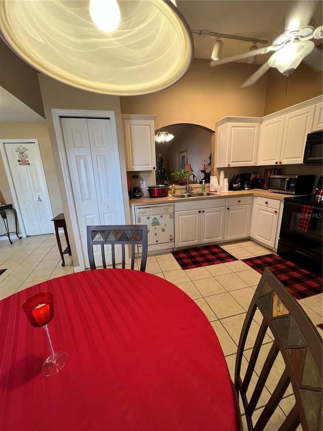 3449 Village Green Ct, Saint Cloud, FL 34772 - kitchen featuring white cabinets, a sink, black appliances, and light tile patterned floors