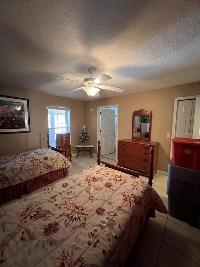 3449 Village Green Ct, Saint Cloud, FL 34772 - bedroom featuring ceiling fan, baseboards, a textured ceiling, and light tile patterned flooring