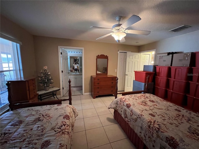 3449 Village Green Ct, Saint Cloud, FL 34772 - bedroom with light tile patterned floors, a textured ceiling, a ceiling fan, visible vents, and baseboards