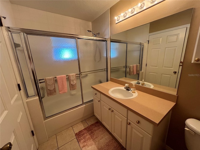 3449 Village Green Ct, Saint Cloud, FL 34772 - full bath featuring combined bath / shower with glass door, vanity, toilet, and tile patterned floors