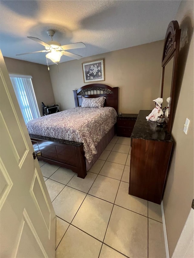 3449 Village Green Ct, Saint Cloud, FL 34772 - bedroom featuring light tile patterned floors, a textured ceiling, and a ceiling fan